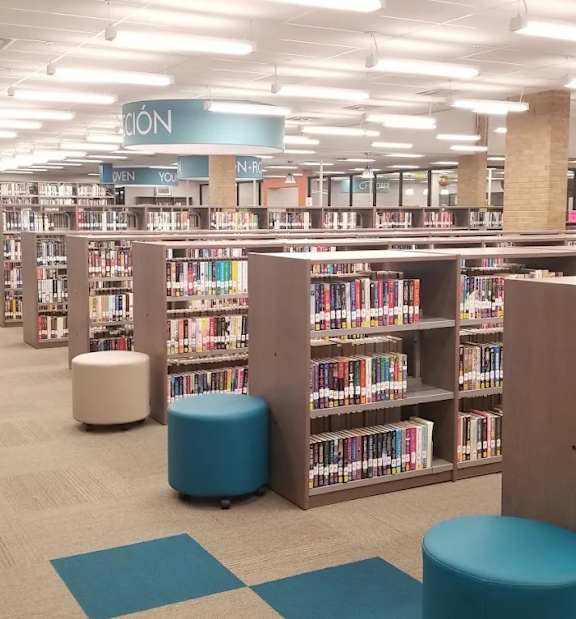 A library with bookshelves and seating areas.