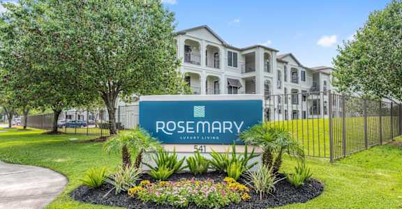A sign for Rosemary Luxury Living in front of a building.