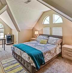 A bedroom with a bed, nightstand, and window.