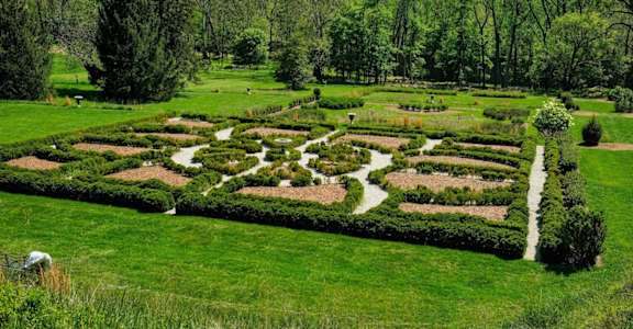 A garden with a lot of green grass and trees at Hampton Plaza Apartments, Towson, MD, 21286