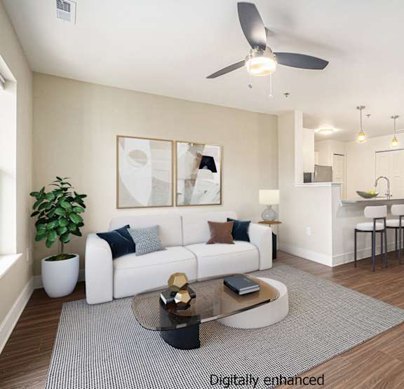 a living room with a couch and a television  at Signature Pointe Apartment Homes, Athens