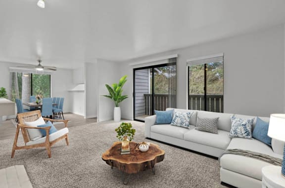 A living room with a white couch, a wooden chair, and a coffee table at Brackett Apartments, Edmonds, WA, 98020