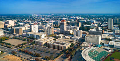 A cityscape with a clear blue sky above.