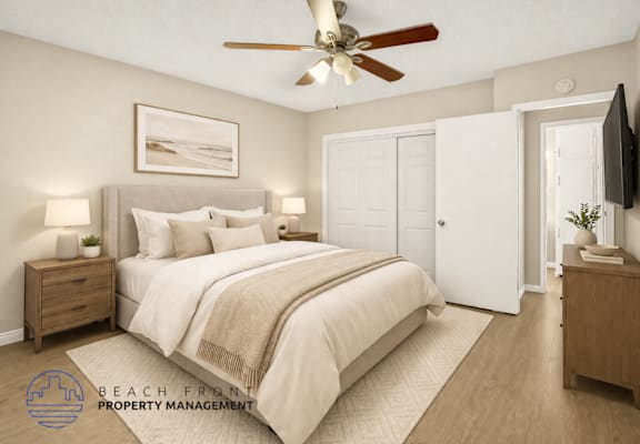 A bedroom with a large bed, a ceiling fan, and a painting on the wall.