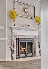 Living room with a fireplace and wood-style flooring at Village at Caldwell in Birmingham, AL