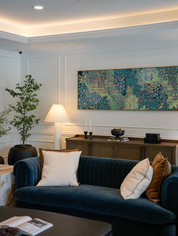 A living room with a brown chair and a white couch.