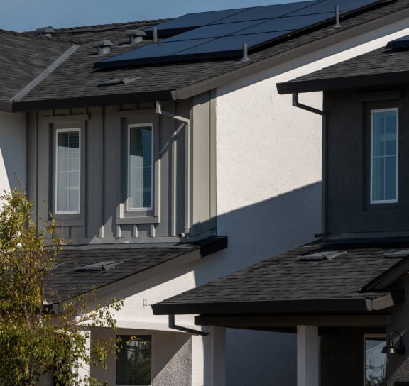a row of houses with solar panels on their roofs