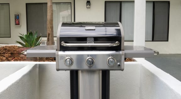 a stainless steel barbecue grill in a courtyard