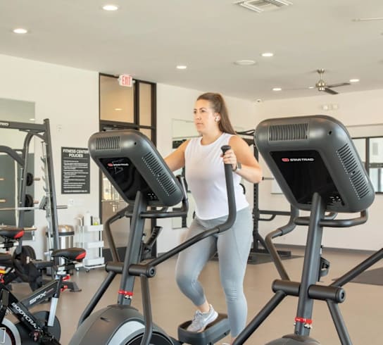 Woman is exercising in a gym at Liberty Flats Apartments, Liberty Township, Ohio