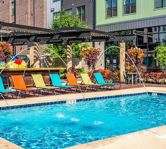 a swimming pool in front of a large building