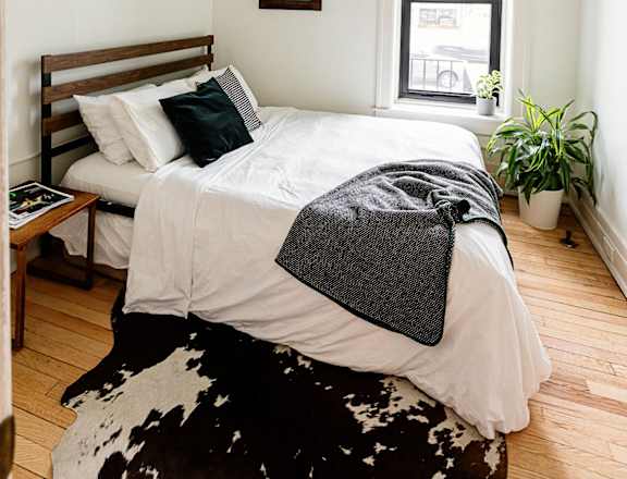 a bedroom with a bed and a window