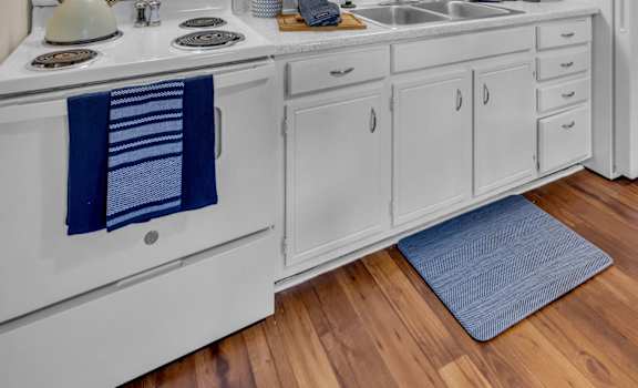 a white kitchen with white cabinets and a sink