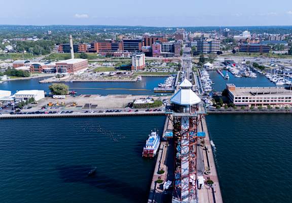 A view of a city from a bridge with a boat docked at the pier.