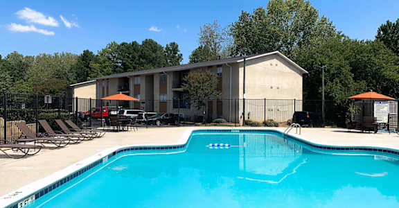 A swimming pool with a building in the background.