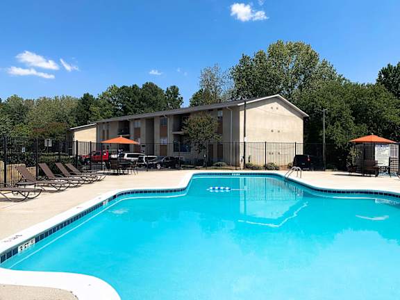 A swimming pool with a building in the background.