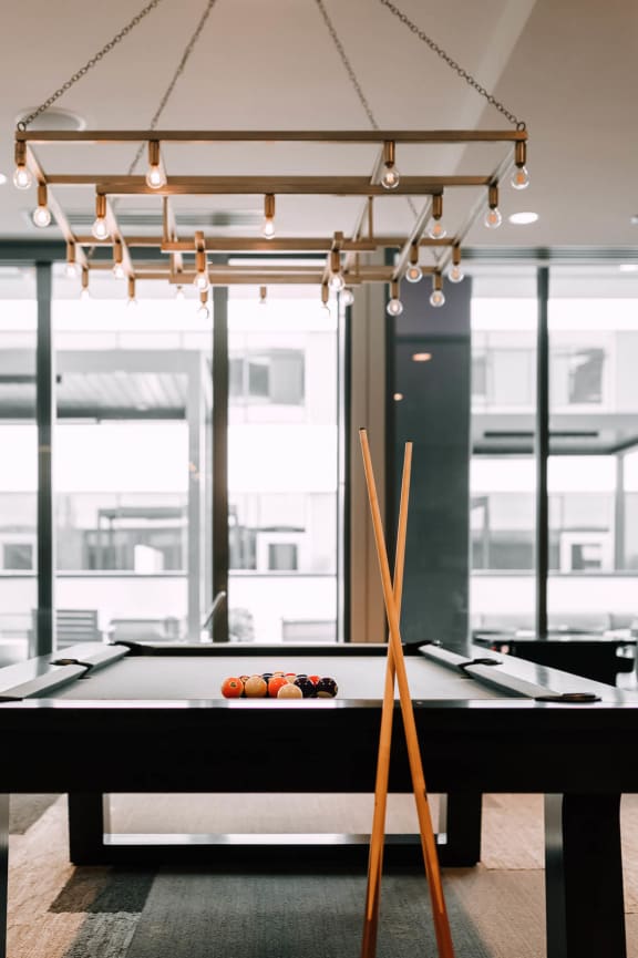 a pool table in a room with glass windows at The Grand Central, Chicago Illinois