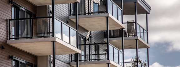 a tall apartment building with balconies on top of it