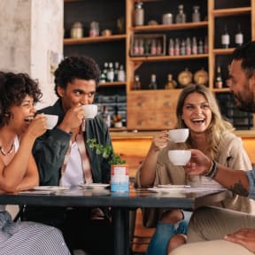 people sitting at a table drinking coffee