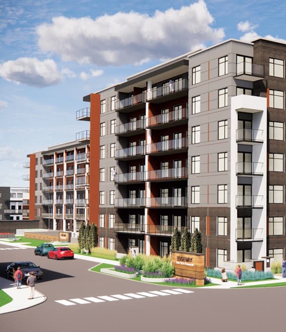 A modern apartment complex with a parking lot in front.