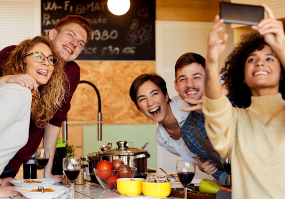 a group of people posing for a picture in a kitchen