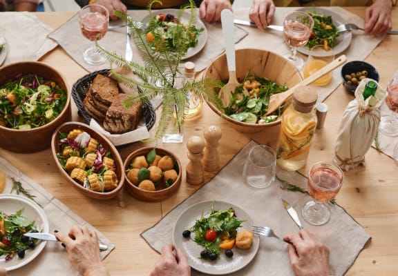 a table full of food and people eating