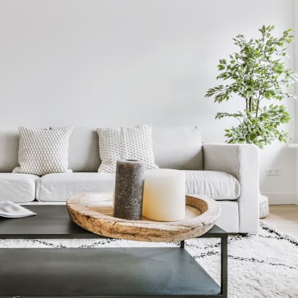a living room with a white couch and a black coffee table