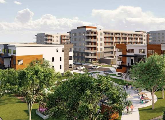 A modern residential area with apartment buildings and greenery.