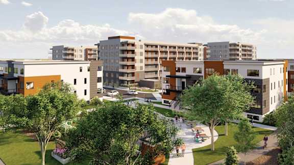 A modern residential area with apartment buildings and greenery.