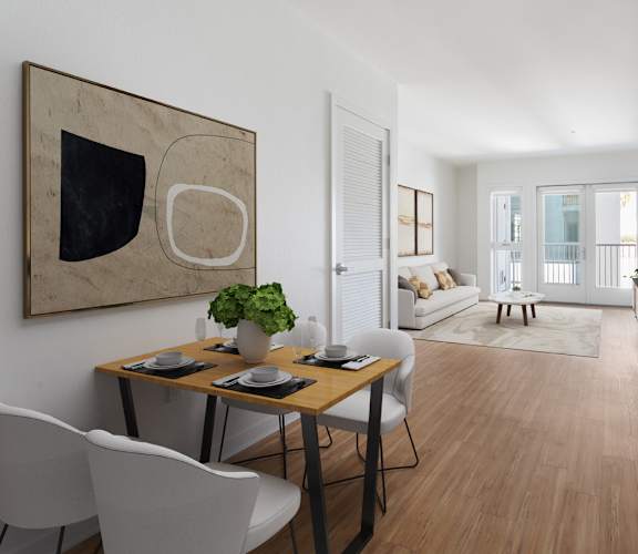 A modern dining room with a wooden table and white chairs.
