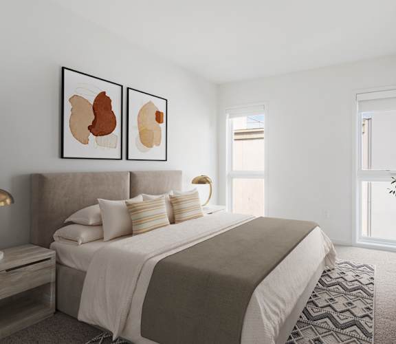A bedroom with a large bed and two framed artworks on the wall.