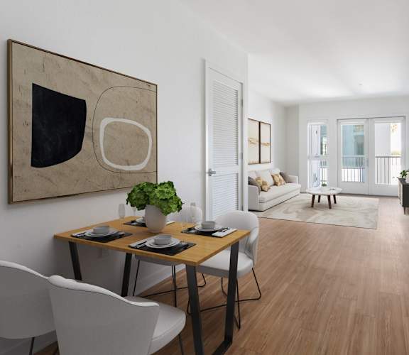 A modern dining room with a wooden table and white chairs.