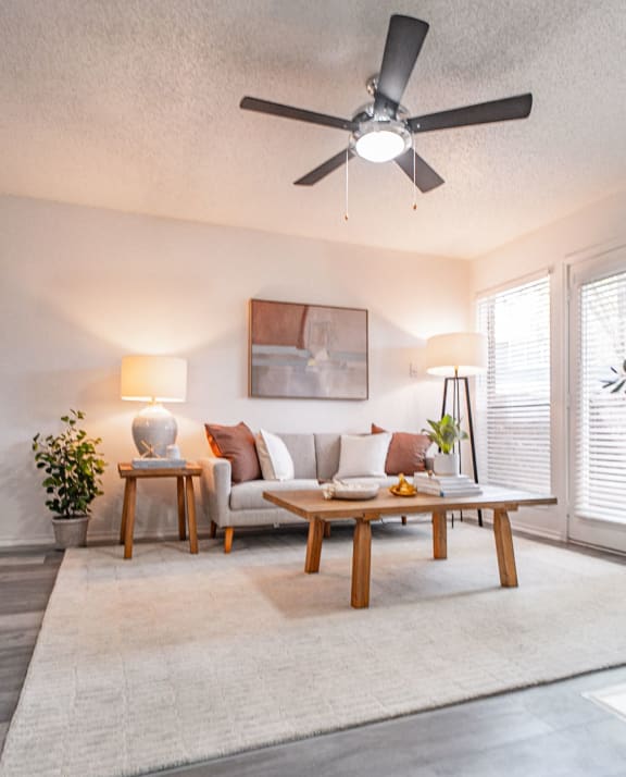 a living room with a ceiling fan and a couch