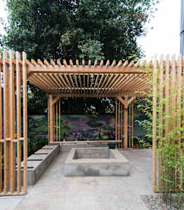 Outdoor courtyard with pergola and fire pit at Kaya Camilla, Portland, OR