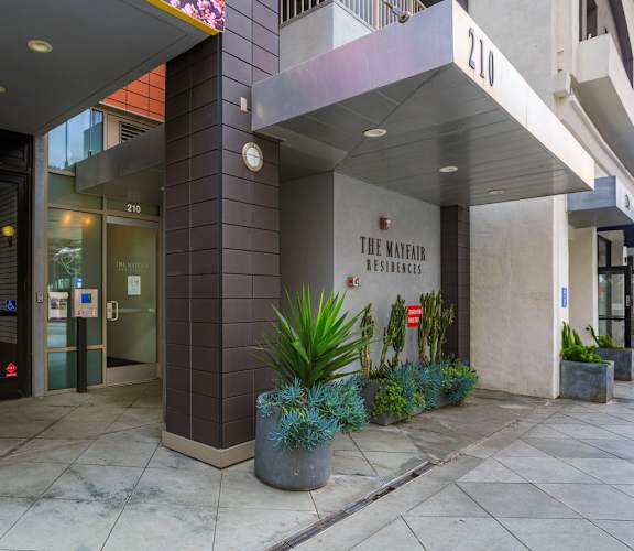 The front of a building with a sign that says "The Mayfair Residences".