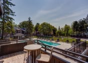 Thumbnail 40 of 50 - Pool view aerial at Commons at Redwood Creek Apartments, Beaverton, OR