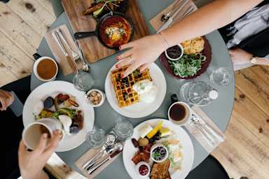 A top view of a table with people having breakfast.