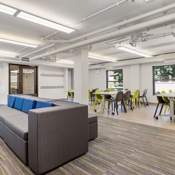 a room filled with furniture and a large window at Eden Commons