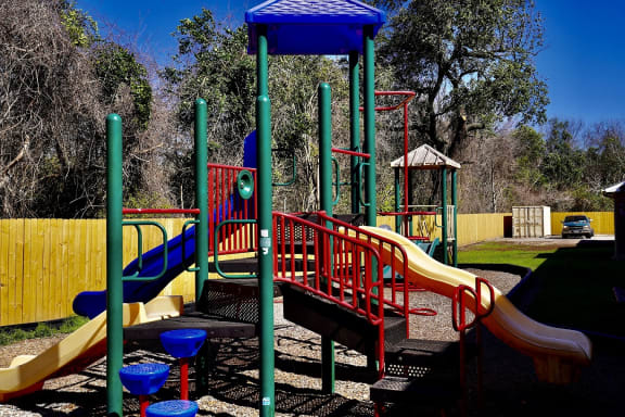 a colorful playground with slides and monkey bars