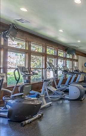 A swimming pool in a residential area with a blue chair at Stoneplace Apartment Homes, Molalla, OR, 97038