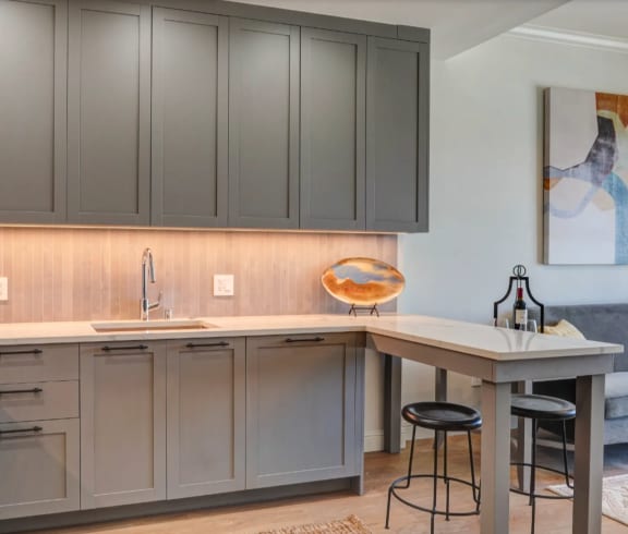 an open kitchen and living room with a couch and a table