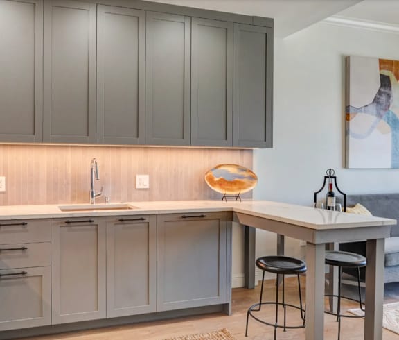 an open kitchen and living room with a couch and a table