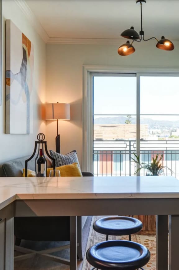 an open kitchen and living room with a couch and a table