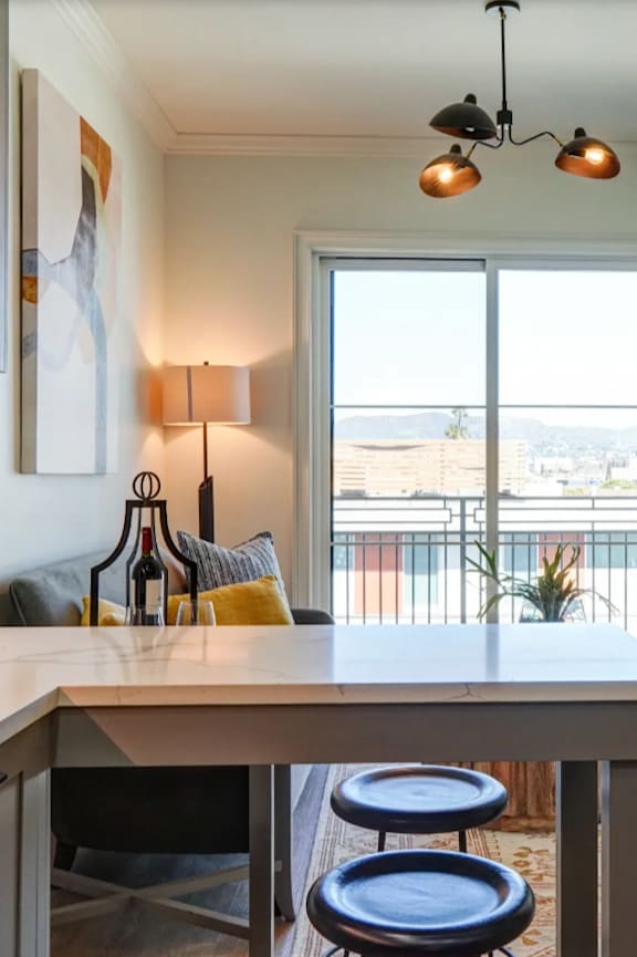 an open kitchen and living room with a couch and a table