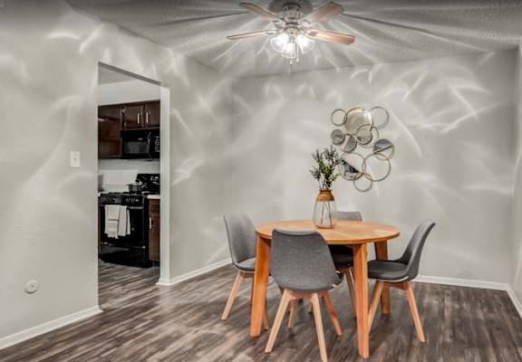 A dining room with a table and chairs.