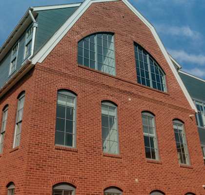 the side of a brick building with a green roof