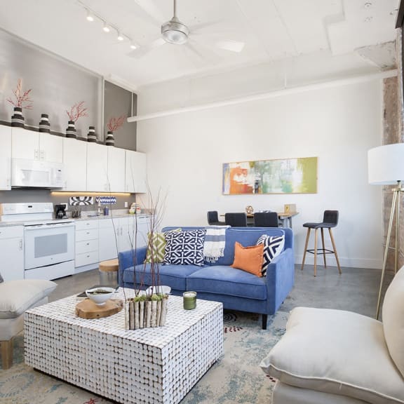 a living room with a blue couch and a table at Parcels at Concourse, Memphis, TN, 38104