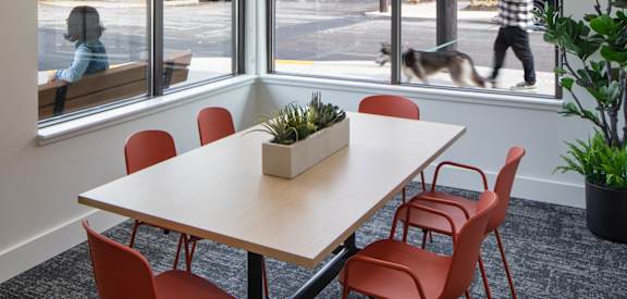 a meeting room with a table and chairs and a man walking down the street