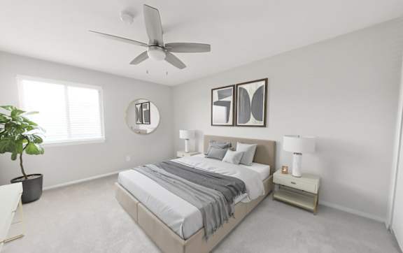 Main bedroom with ceiling fan and walk-in closet