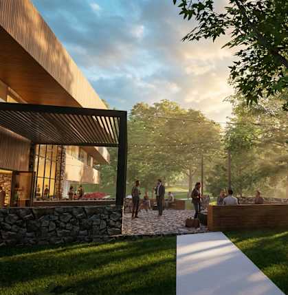 A modern house with a stone wall and people walking around outside.