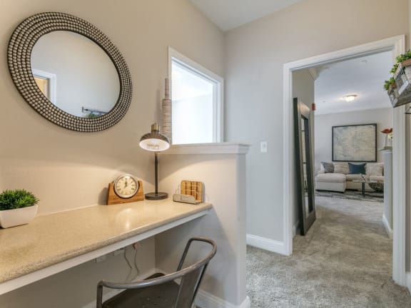 a home office with a desk and a mirror